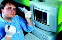 A USDA geneticist prepares to load PCR samples onto an automated DNA sequencer.