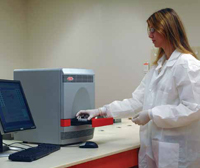 DuPont Qualicon technician inserts samples into the BAX System instrument for rapid indication of whether specific bacteria are present.