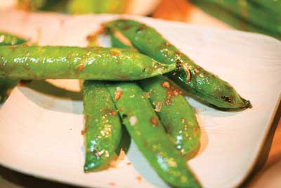 Peas with sweet soy glaze and sriracha chili sauce.