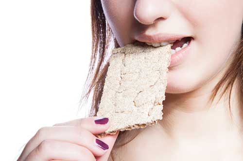 Woman eating cracker.