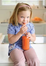 Child drinking vegetable juice.