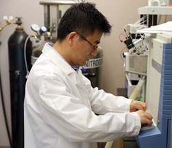 Shengmin Sang makes adjustments to his laboratory’s mass spectrometer.