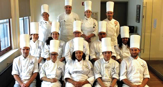 Syrena Johnson (middle row, right) graduates from the International Culinary Center