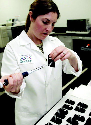 Fig. 6—An Affymetrix scientist injects a sample into a microarray for testing. If RNA in the sample matches a DNA probe on the array, there will be a perfect complement and the RNA will pair with its partner probe.
