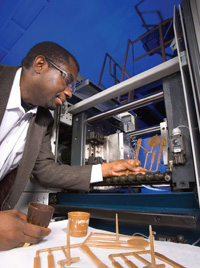 The demand for agricultural products for nontraditional uses such as bioenergy or bio-based materials can potentially change agricultural production patterns, food availability, and food prices. Food Technologist Charles Onwulata uses an injection molder to modify whey protein structures for food and nonfood product development.