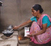 Woman in India cooking a meal with salt fortified with iodine and iron.