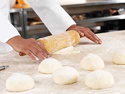 Gluten affects dough structure by making it elastic and extensible.