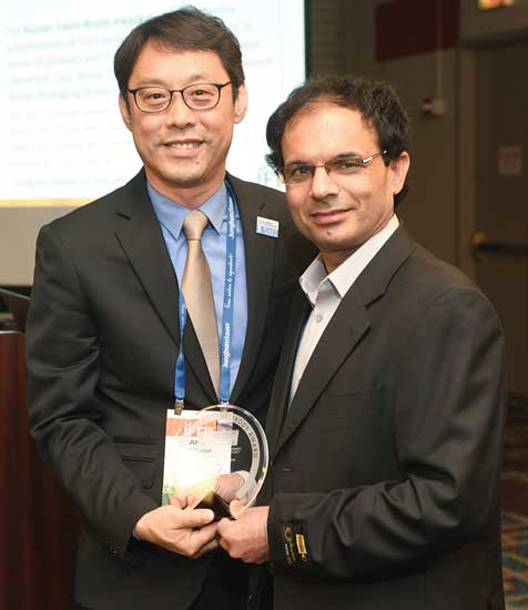 The incoming chair of the Food Packaging Division, Shyam Sablani (right), presents the 2018 Riester-Davis-Brody Award to Jung Han (left).