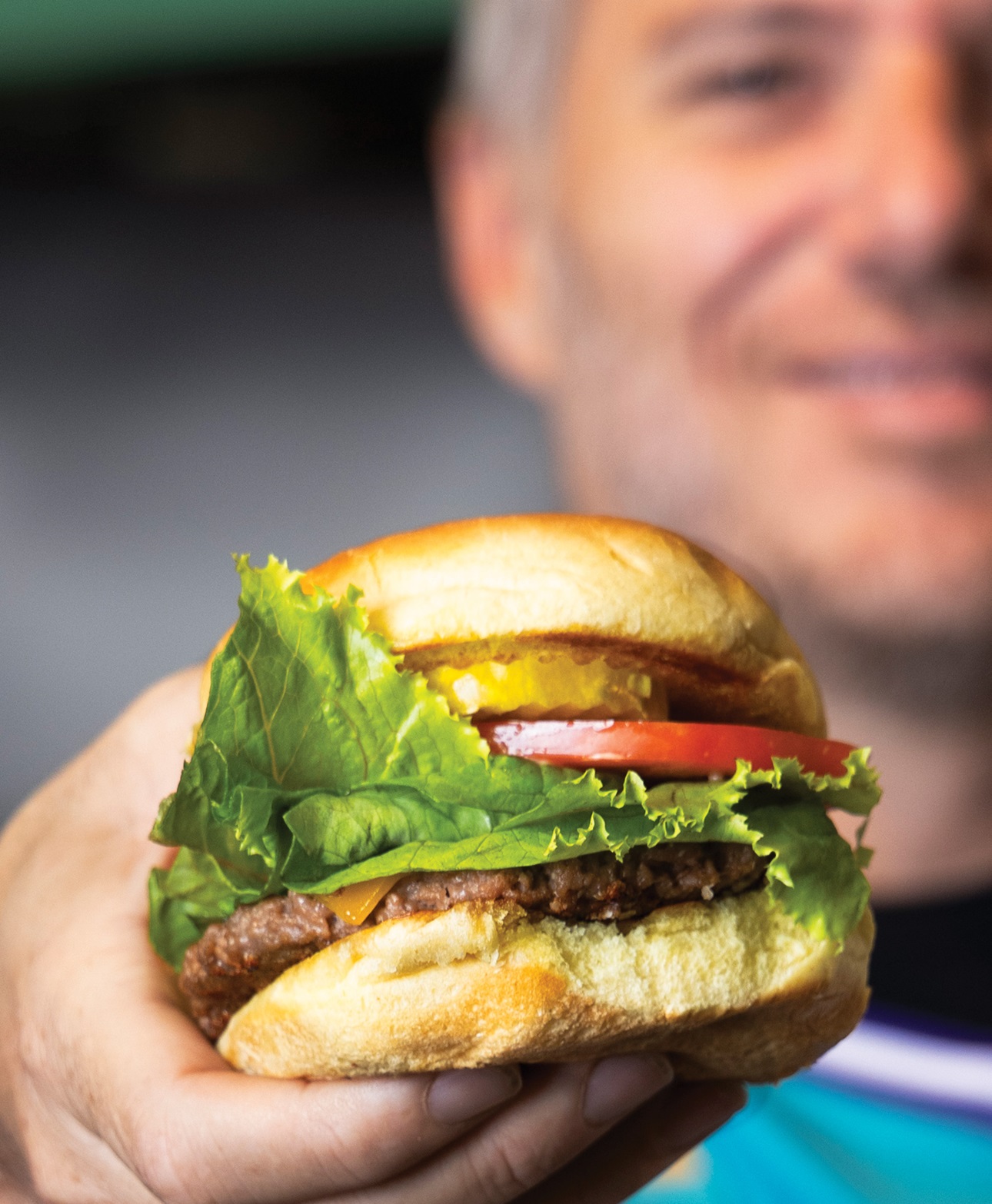 Spike Mendelsohn holding a Beyond Meat patty burger