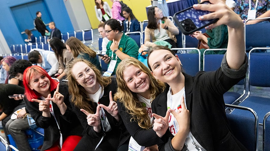 Four students seated and posing for a selfie at IFT FIRST.