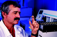 USDA chemist examines distilled steam concentrates from catfish fillets before analyzing the off-flavor compounds 2-methylisoborneol and geosmin by an automated gas chromatograph–mass spectrometer.