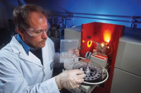 USDA chemist Joseph Domek measures magnesium content of a sample with an atomic absorption spectrophotometer. 