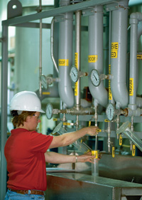Plant employee samples production of 200-proof ethanol.