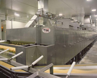 Multistage conveyor dryer, shown here processing French fries for the fast-food industry, provides uniform air velocity and temperature distribution throughout the dryer.