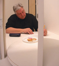 A tester in an isolation booth as seen through the hatch from the serving galley at a Peryam & Kroll Research facility. The serving tray revolves to provide privacy for the tester while the next sample is prepared by the analyst.