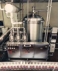Beverage system consists of a water pre-cooling/deaeration tank, proportioner, and cooler/carbonator and is used in processing carbonated beverages that are cold-filled.