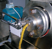 This twin screw extruder is shown starting up on corn meal. The extruder can make pellets that are flaked, puffs, or filled pillows.