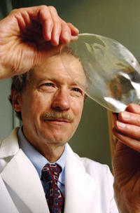 John Krochta, Professor of Food Science and Technology at the University of California, Davis, is shown holding up one of the whey protein films patented in 1996 for potential coating applications on nuts, dried foods, and fruits.