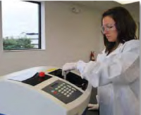 Researcher places a specially designed tube containing a sample into the pressure chamber of Pressure BioSciences Inc.’s Barocycler instrument. Pressure cycling breaks cells and tissues and releases cell contents such as proteins and DNA for subsequent analysis.