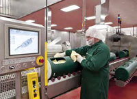 Operator loads product in flexible packaging into the high-presssure processing system at Sandridge Food.