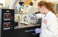 DuPont technician sets up the Oxidative Stability Instrument for testing Pioneer’s high-oleic soybean oil.