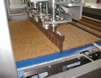 A bank of Branson Ultrasonics horns slicing granola.