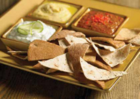 Not too long ago, potato chips and French onion dip prevailed. But today, a wide range of snacking options are available, including this pairing of whole-grain chips with an exotic Mediterranean dip.