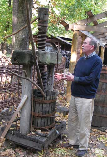 Peter Clark inspects antique food press.