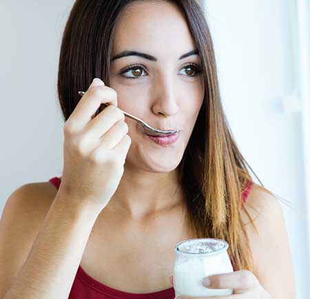 Woman eating yogurt