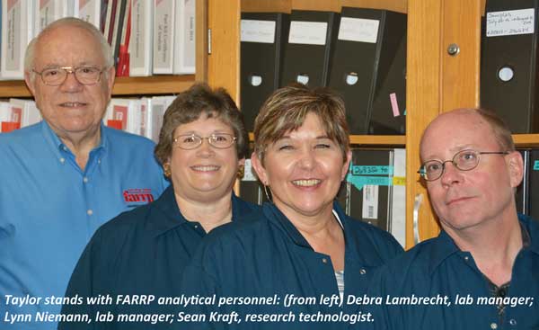 Taylor stands with FARRP analytical personnel: (from left) Debra Lambrecht, lab manager; Lynn Niemann, lab manager; Sean Kraft, research technologist.