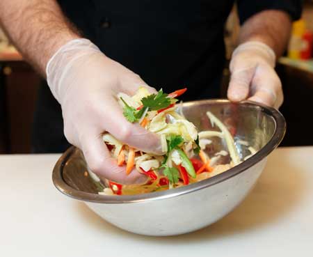 Worker mixing salad