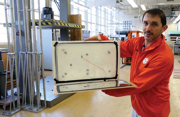 Gregory Batt holds an iteration of the triboelectricity harvester.