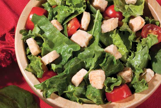 Salad with salmon cubes.