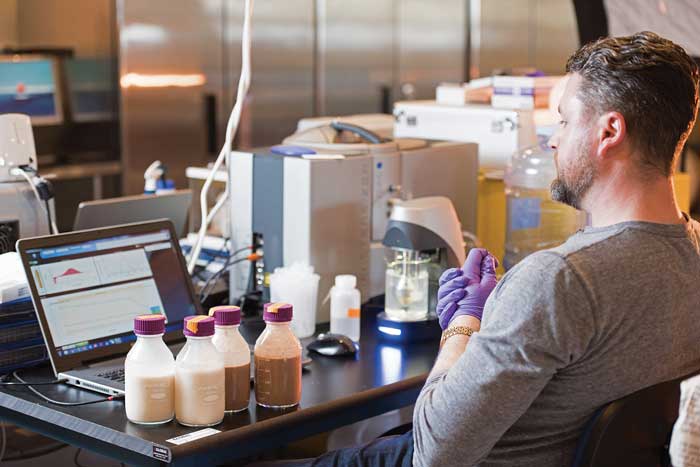 A technician measures the properties of Ripple pea milk. 