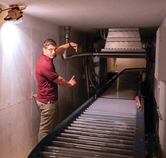 Benjamin O’Neil demonstrates the electron beam accelerator.