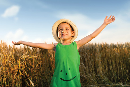 Happy child in wheat field.