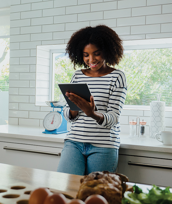 woman on tablet in kitchen
