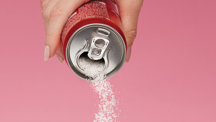 Sweetener pouring from soda can.