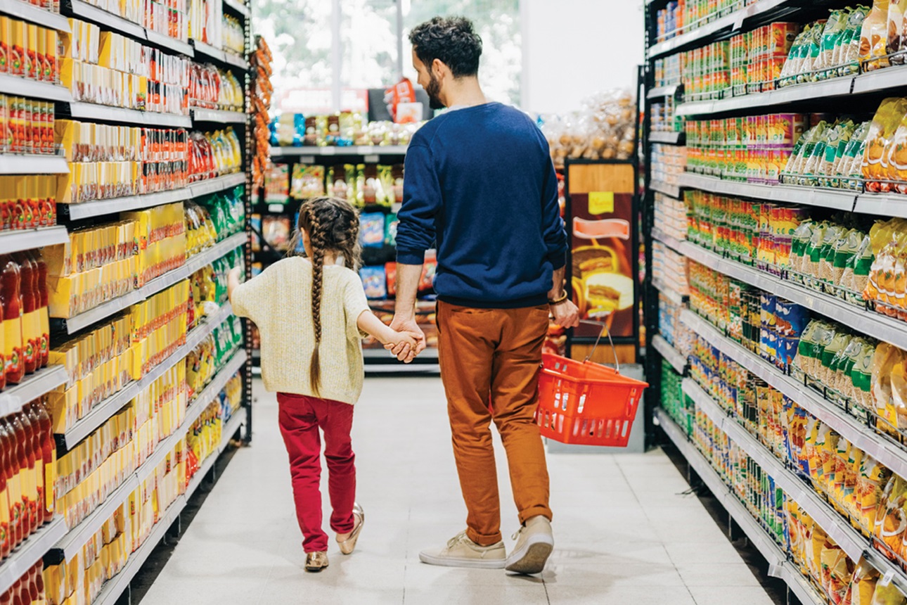 Father and daughter shopping at grocery store.
