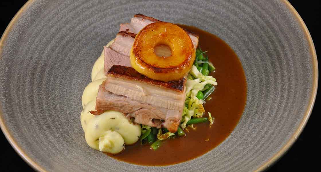 Cider-braised pork belly, buttered cabbage and thyme mash