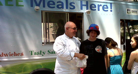 Chef Collazo hands out free lunches to students during the summer