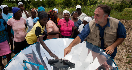 Jose Andres demonstrates how to use a solar cookstove in Haiti