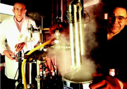 Fig. 1—Inventors George Fanta (left) and Kenneth Eskins prepare starch–lipid composites using a steam jet cooker