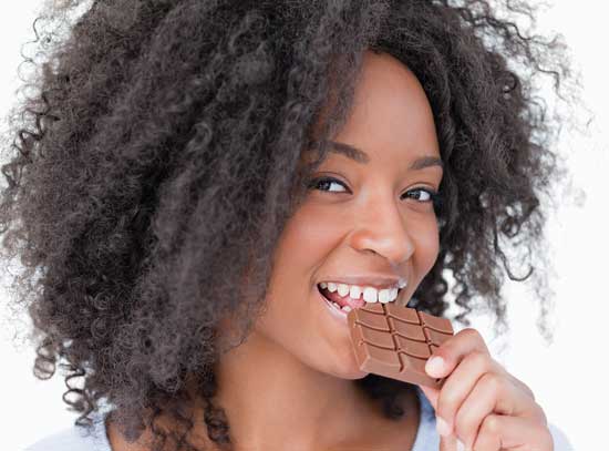 Woman eating milk chocolate.