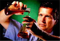 Fig. 6 (right)—Author Hicks checks the quality of the corn fiber oil.