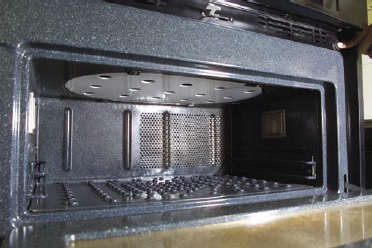 Fig. 2—Interior of a combination microwave–jet-impingement oven (Thermador JetDirect oven, model CJ302UB, technology licensed from Enersyst Development Center, Dallas, Tex.). The inside of the oven has dimensions 0.61 m x 0.375 m x 0.235 m (height). The microwaves are introduced from the top, and the air jets are introduced from both the top and the bottom.