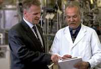 Werner Bauer (left),the first Marcel Loncin Research Prize recipient,discusses lab results with Ernesto Dalan of the Nestlé Research Center.