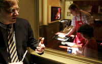 Brian Wansink, director of the Cornell Food and Brand Lab, views through one-way glass a consumer participating in a study to determine how package shape influences food intake and satisfaction.