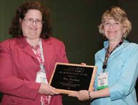 Michele Perchonok (right) presents the Riester-Davis award to Kay Cooksey (left).