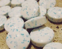 Encapsulated flavor particles in breath mints.